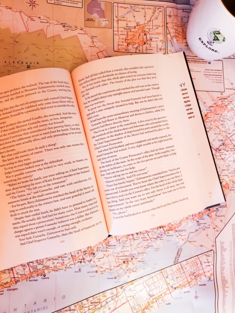 Image of a book lying open on an open map